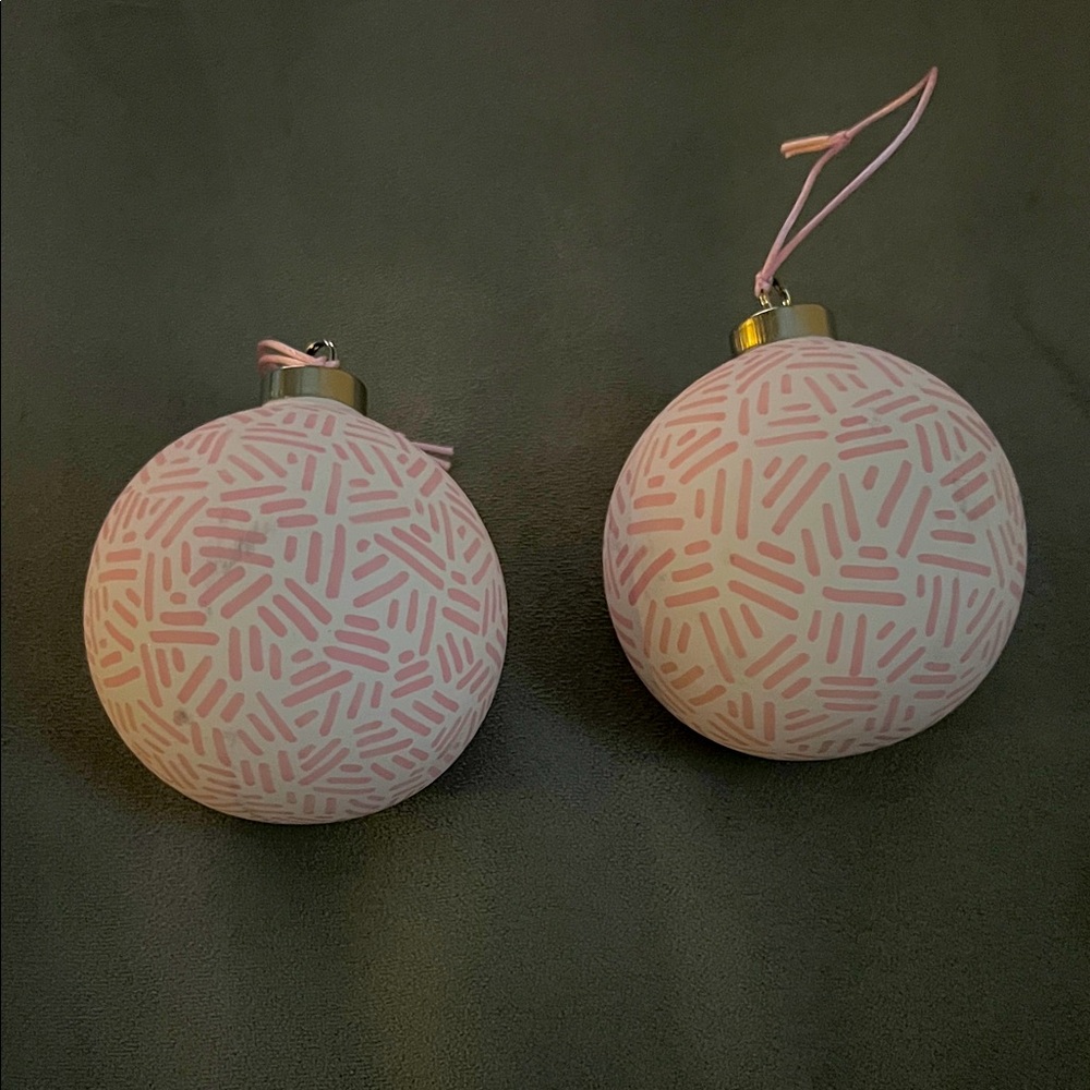 TWO ceramic ornaments pink and white print